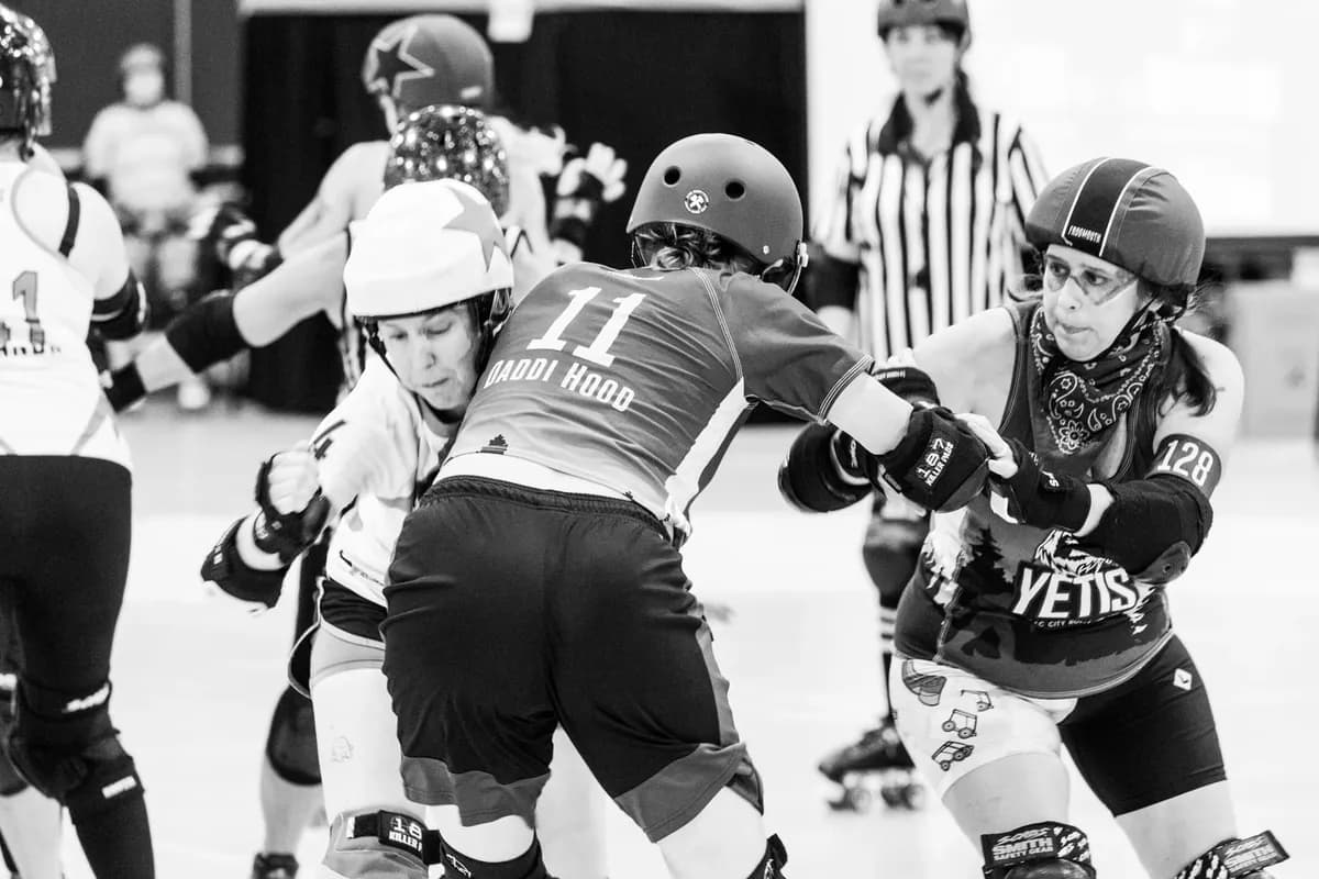 Roller derby blockers making controlled contact during a bout
